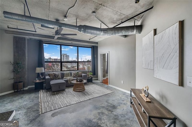 unfurnished room featuring a ceiling fan, concrete floors, and baseboards