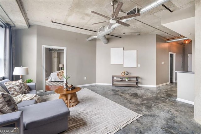 living room featuring concrete floors, baseboards, and a ceiling fan