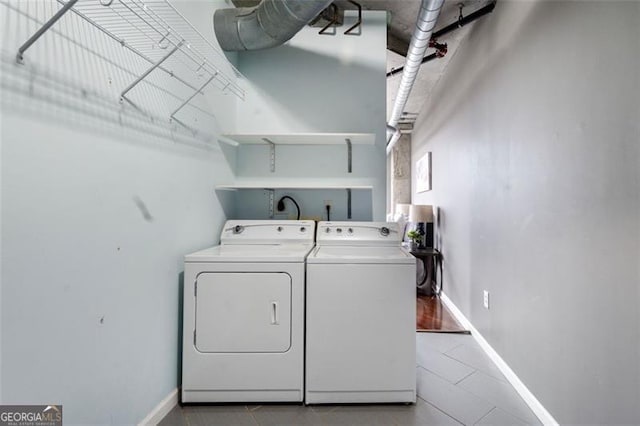 laundry room with laundry area, baseboards, and separate washer and dryer