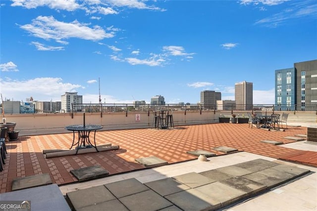 view of community with a patio area and a view of city