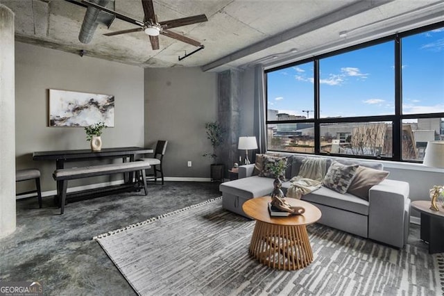 living room with baseboards and a ceiling fan