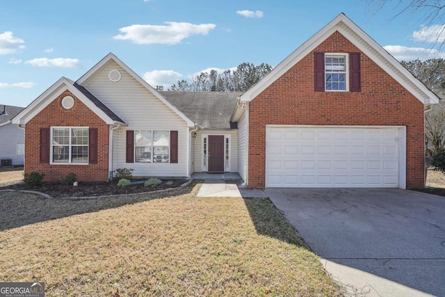 traditional-style home with a front yard, brick siding, and driveway