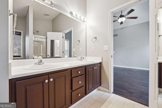 bathroom with ceiling fan, double vanity, tile patterned flooring, and a sink