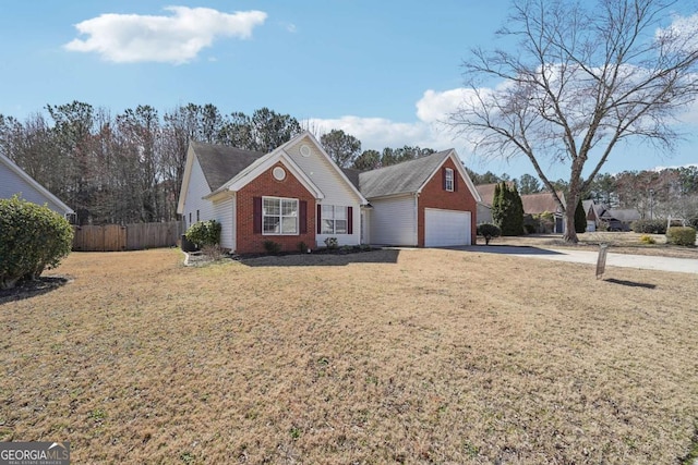 ranch-style home with fence, a front lawn, concrete driveway, and brick siding