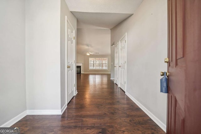 hallway with wood finished floors and baseboards