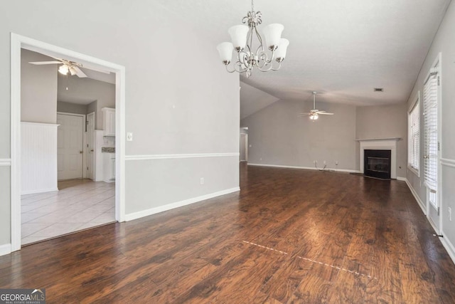 unfurnished living room featuring a glass covered fireplace, wood finished floors, lofted ceiling, and ceiling fan with notable chandelier