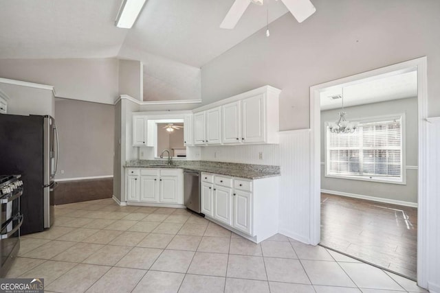 kitchen featuring white cabinetry, appliances with stainless steel finishes, a sink, and ceiling fan with notable chandelier