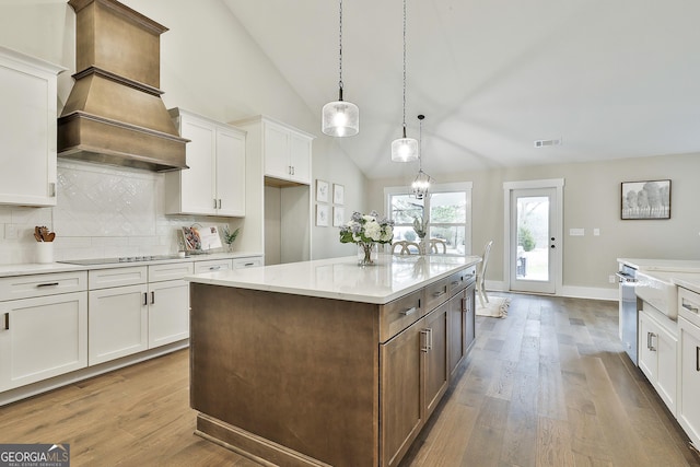 kitchen featuring visible vents, black electric cooktop, and white cabinetry