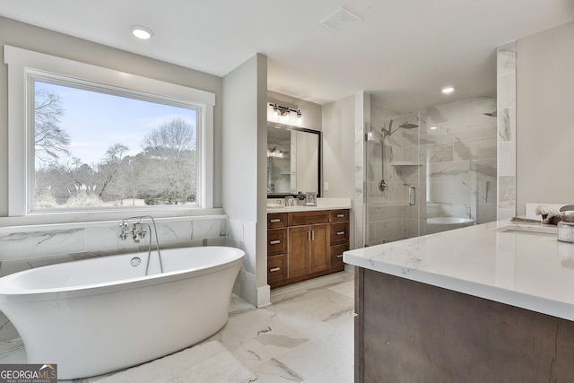 full bath featuring visible vents, marble finish floor, a freestanding bath, vanity, and a shower stall