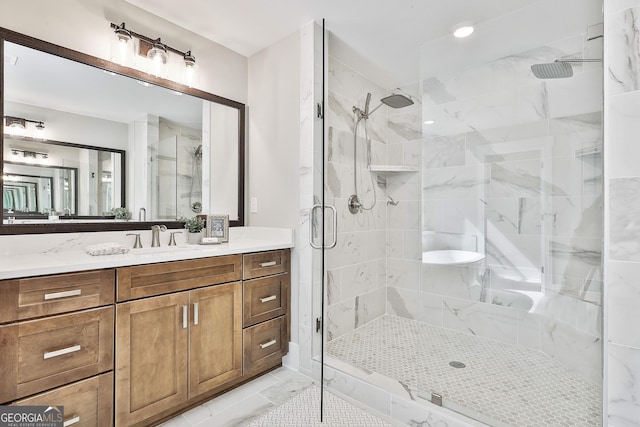 full bath with marble finish floor, a shower stall, and vanity