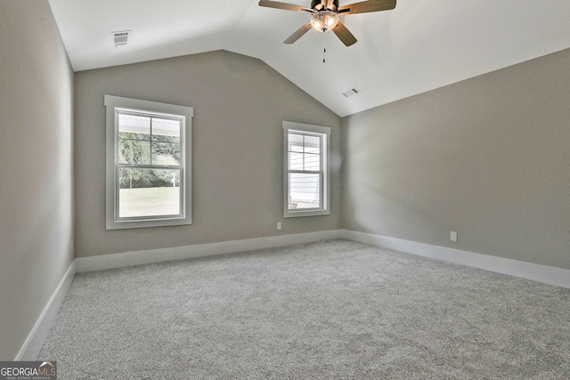 unfurnished room featuring lofted ceiling, carpet floors, ceiling fan, and visible vents