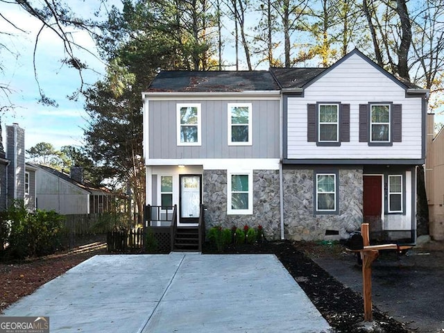 view of front facade with crawl space and stone siding