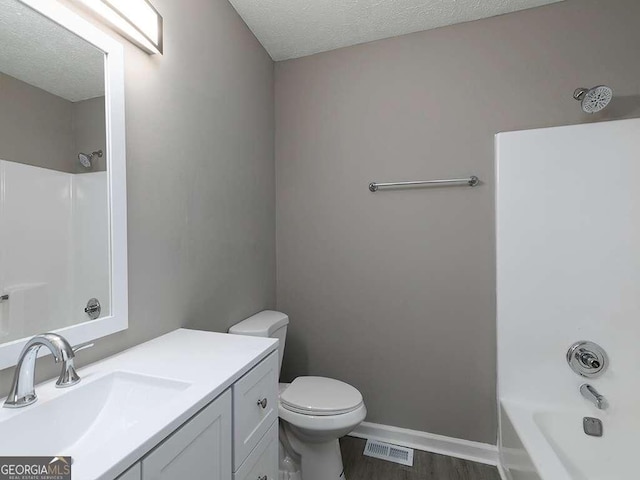 full bathroom featuring visible vents, a textured ceiling, vanity, and wood finished floors