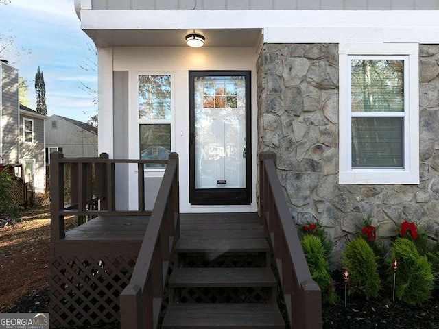 property entrance featuring stone siding