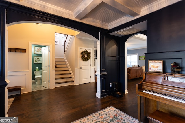 interior space featuring arched walkways, beam ceiling, crown molding, and stairs