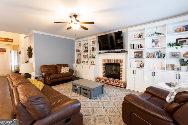 living room featuring a fireplace, ornamental molding, and a ceiling fan