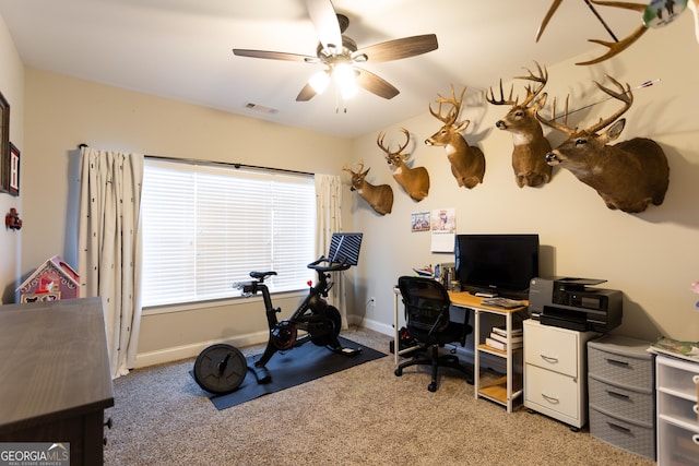 office featuring visible vents, ceiling fan, light carpet, and baseboards