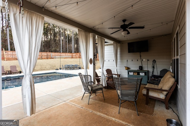 view of patio / terrace featuring a fenced in pool, fence, and a ceiling fan