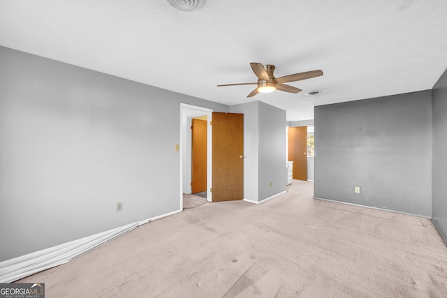 unfurnished bedroom with carpet flooring, baseboards, visible vents, and a ceiling fan