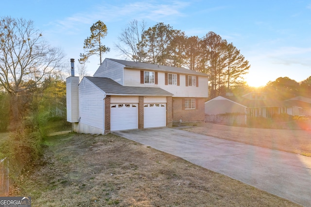 view of front of property with brick siding, a chimney, and concrete driveway