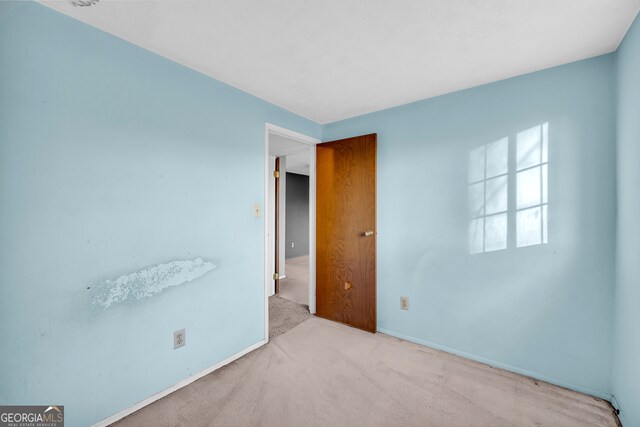 bedroom featuring baseboards and carpet flooring