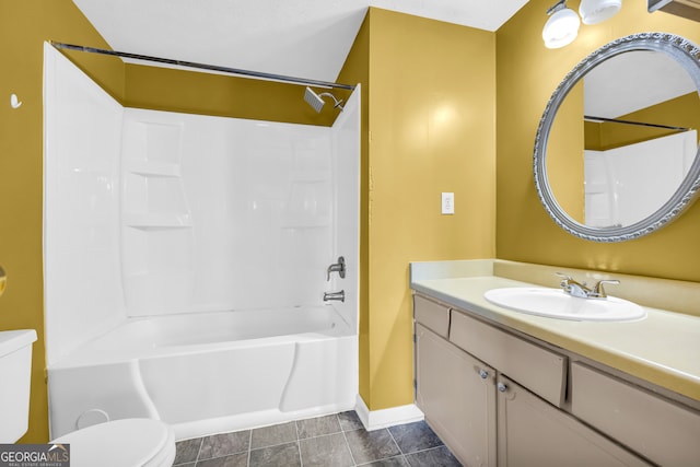 bathroom featuring toilet, shower / washtub combination, tile patterned flooring, baseboards, and vanity