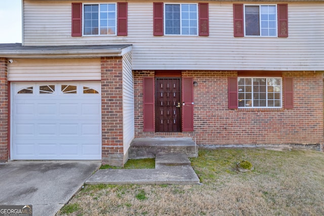 view of front of house with concrete driveway, an attached garage, and brick siding