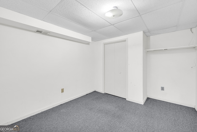 unfurnished bedroom featuring a drop ceiling, visible vents, and carpet flooring