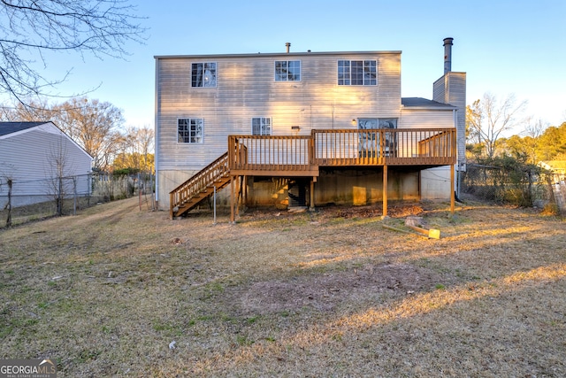 rear view of property featuring a chimney, a wooden deck, stairs, and fence