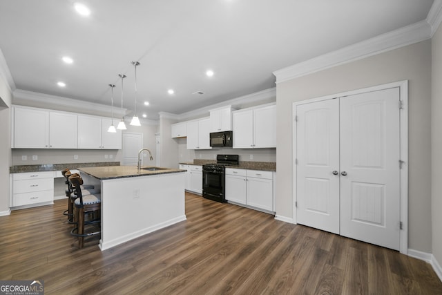kitchen with dark wood-style floors, crown molding, black appliances, white cabinetry, and a sink