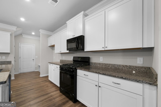 kitchen with visible vents, ornamental molding, dark wood-type flooring, white cabinetry, and black appliances