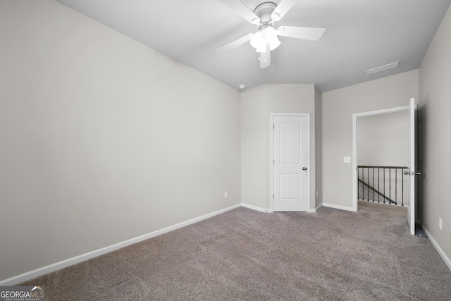 unfurnished bedroom featuring carpet flooring, ceiling fan, visible vents, and baseboards
