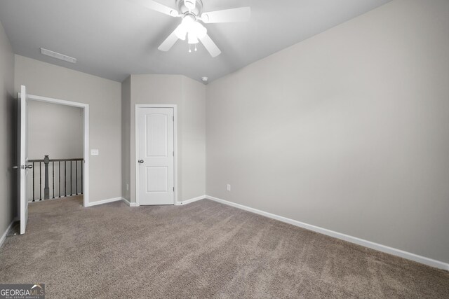 unfurnished bedroom with carpet flooring, a ceiling fan, and baseboards