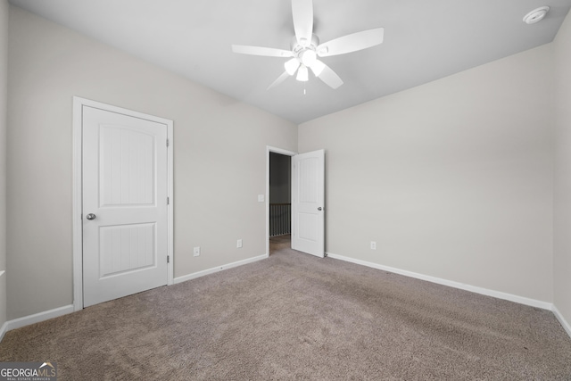 unfurnished bedroom with carpet floors, ceiling fan, and baseboards