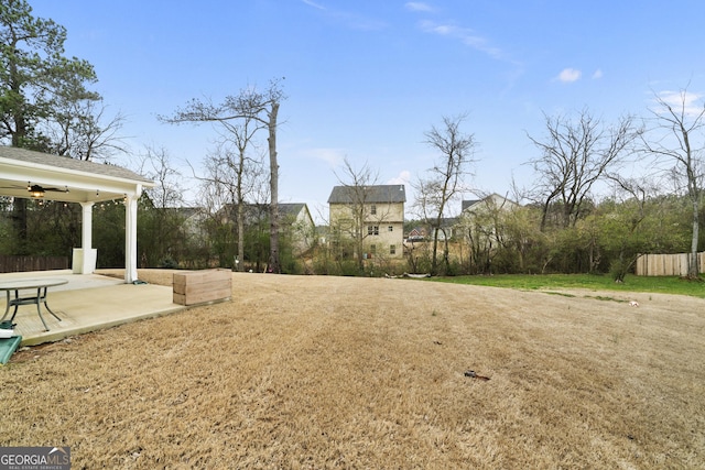 view of yard featuring a patio area, fence, and a ceiling fan