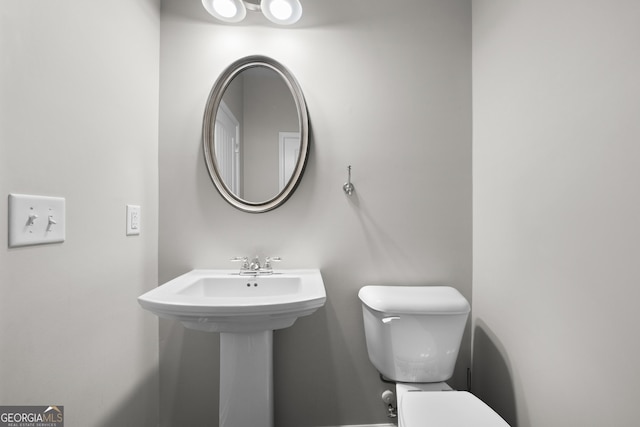 half bathroom featuring toilet