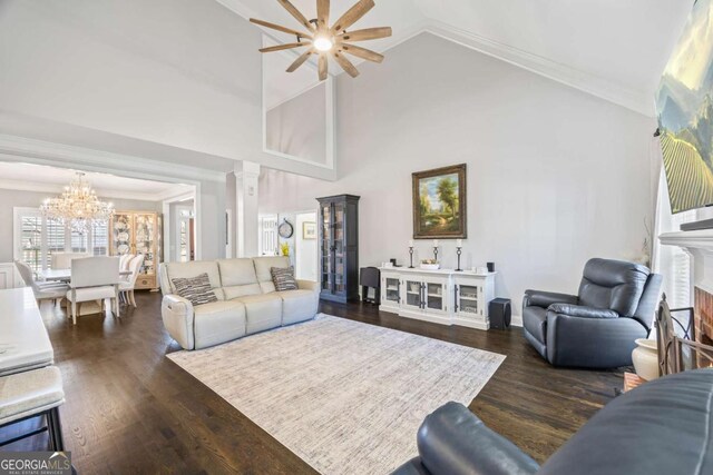 living room featuring a fireplace, high vaulted ceiling, dark wood finished floors, and crown molding