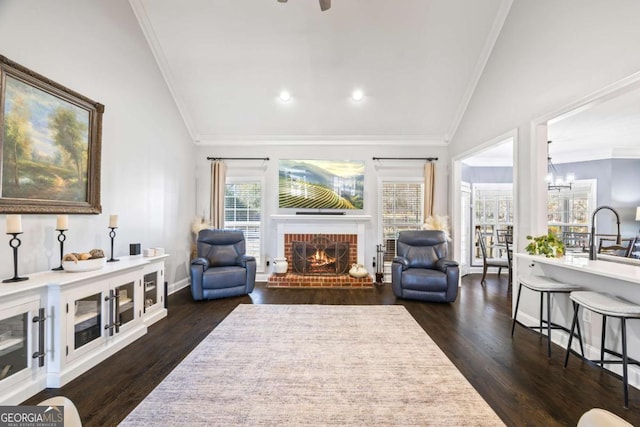 living room featuring lofted ceiling, baseboards, ornamental molding, a brick fireplace, and dark wood finished floors