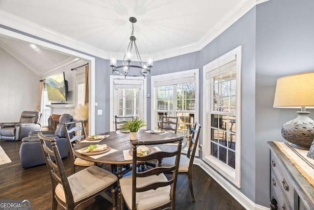 dining room with a notable chandelier, crown molding, and dark wood-style flooring