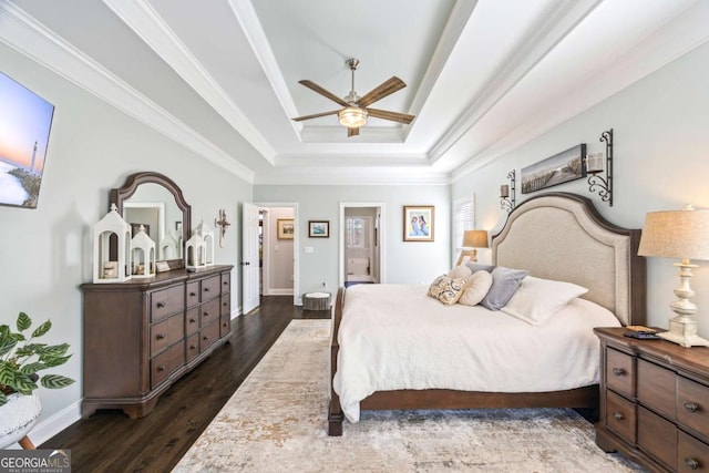 bedroom with a ceiling fan, baseboards, ornamental molding, dark wood-style floors, and a raised ceiling