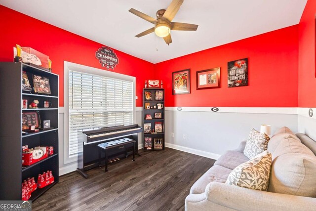 living area with ceiling fan, baseboards, and wood finished floors