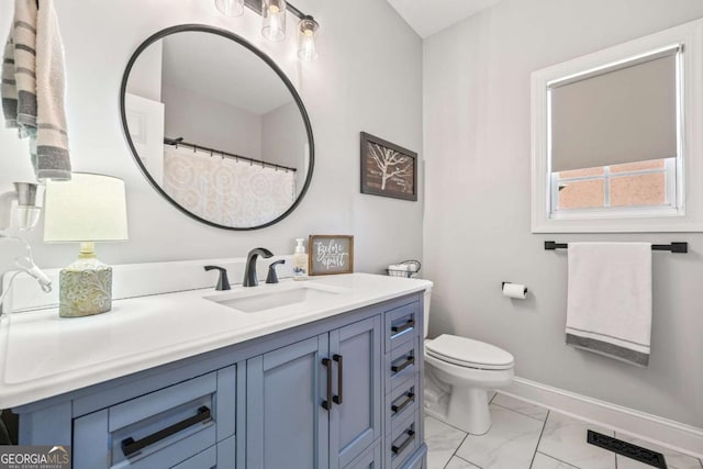 full bathroom with toilet, marble finish floor, baseboards, and vanity