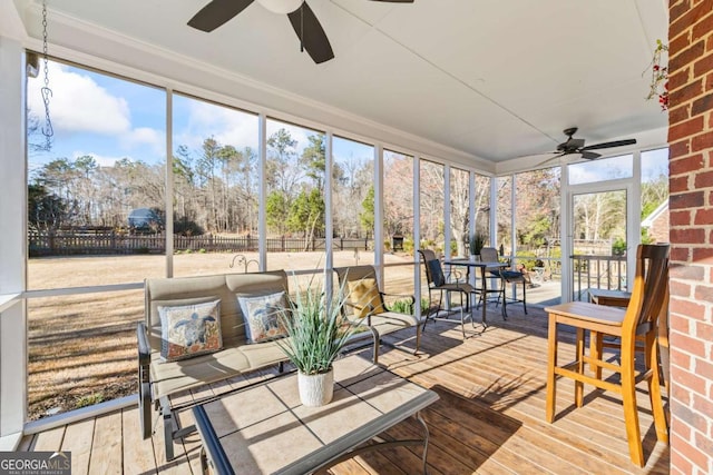 sunroom featuring a ceiling fan