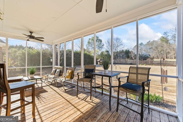 sunroom with a healthy amount of sunlight and a ceiling fan