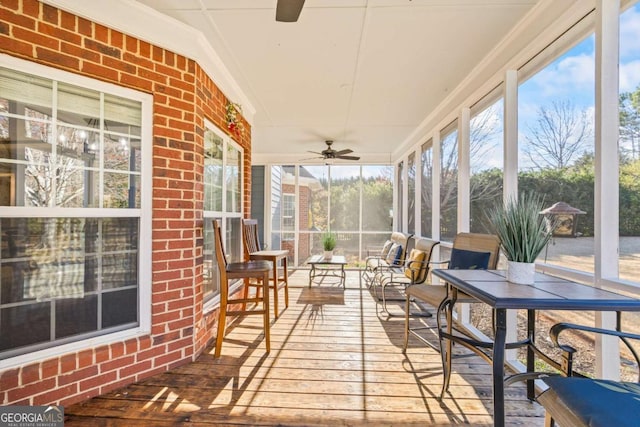 sunroom featuring ceiling fan