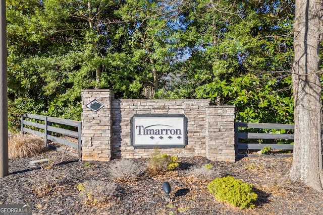 community sign featuring fence