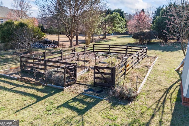 view of yard with a vegetable garden and fence