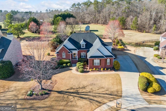 view of front of home with driveway and brick siding