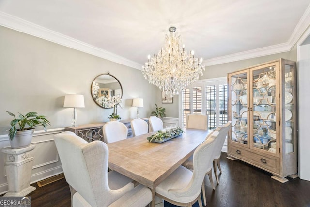 dining space with crown molding, wood finished floors, and wainscoting