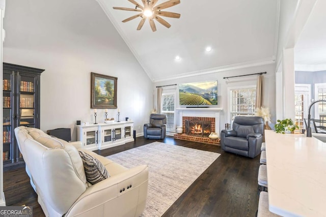 living room featuring crown molding, a brick fireplace, dark wood-style floors, and a healthy amount of sunlight